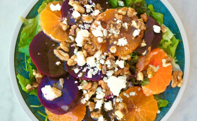 Beet salad with tangerines and feta on a plate